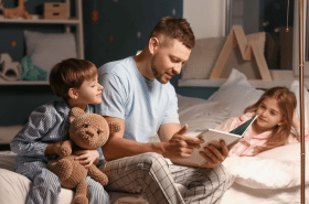 Father reading a story to children before bedtime