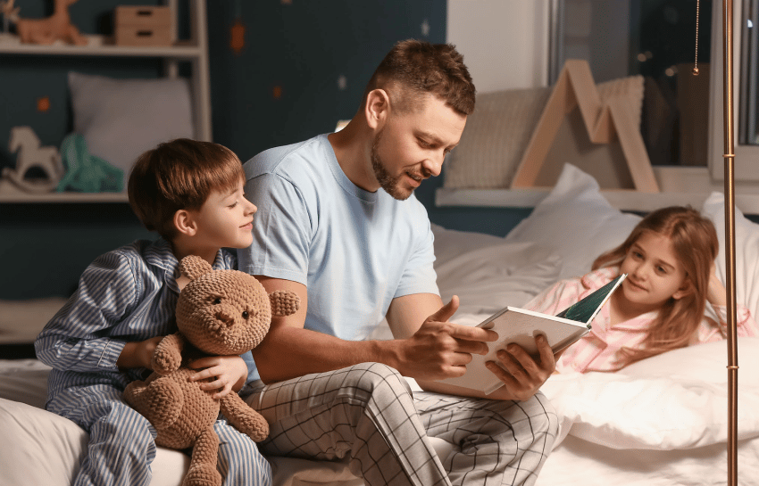 Father reading a story to children before bedtime