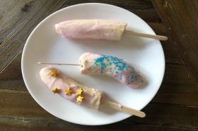 frozen banana yogurt popsicles decorated with sprinkles
