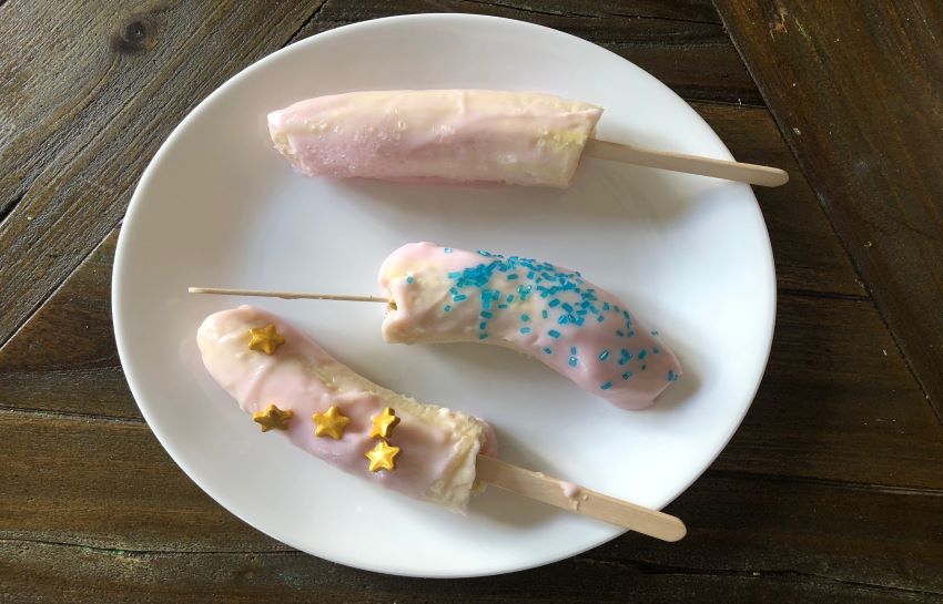 frozen banana yogurt popsicles decorated with sprinkles