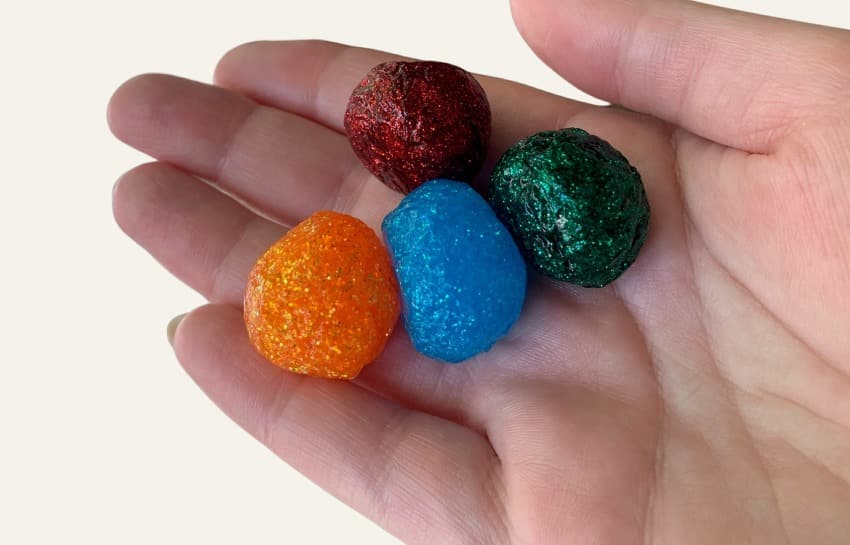 Hand holding DIY glitter bouncy balls