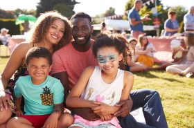 Diverse family having fun at a children's carnival