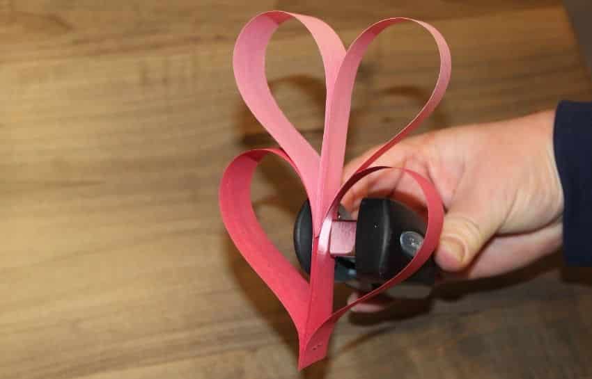 Two construction paper hearts stapled together to make a heart garland