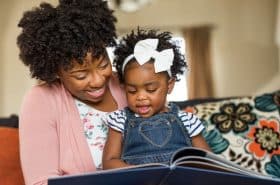 Mother and Daughter Reading A Story Together