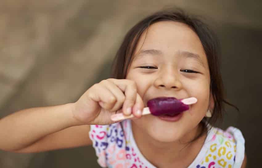 child enjoying a yogurt smoothie pop