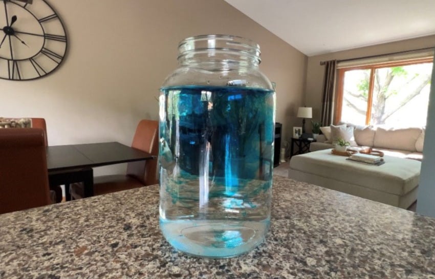 food coloring dilating in glass jar to make fireworks in a jar