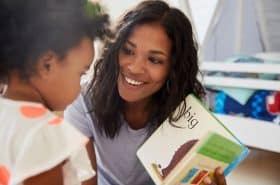 Mother reading a picture to her childbook