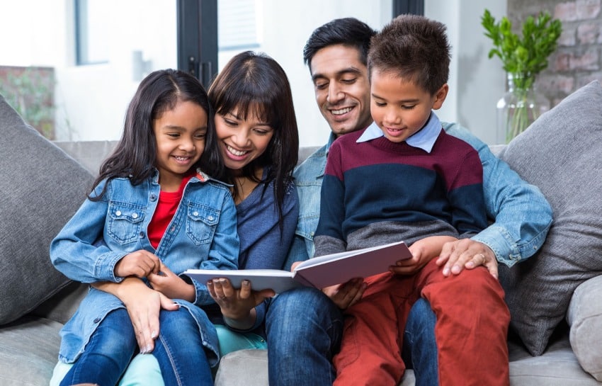 family reading a story together on the couch