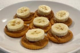 bananas and peanut butter on ritz crackers