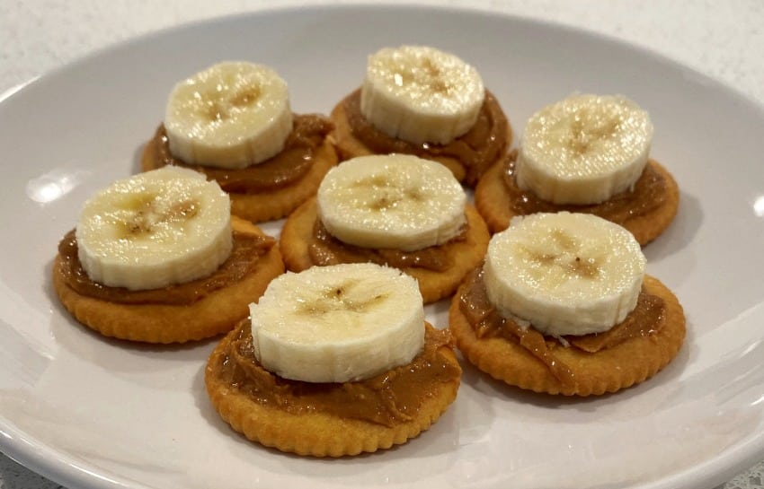 bananas and peanut butter on ritz crackers