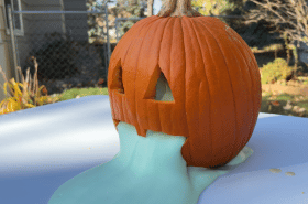 green foam oozing out of pumpkin outside