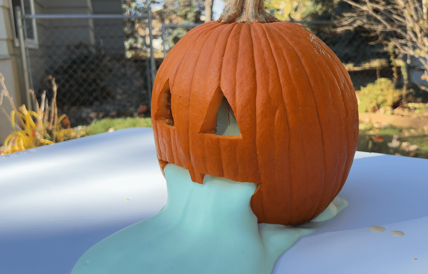 green foam oozing out of pumpkin outside