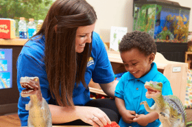 Daycare teacher playing with child