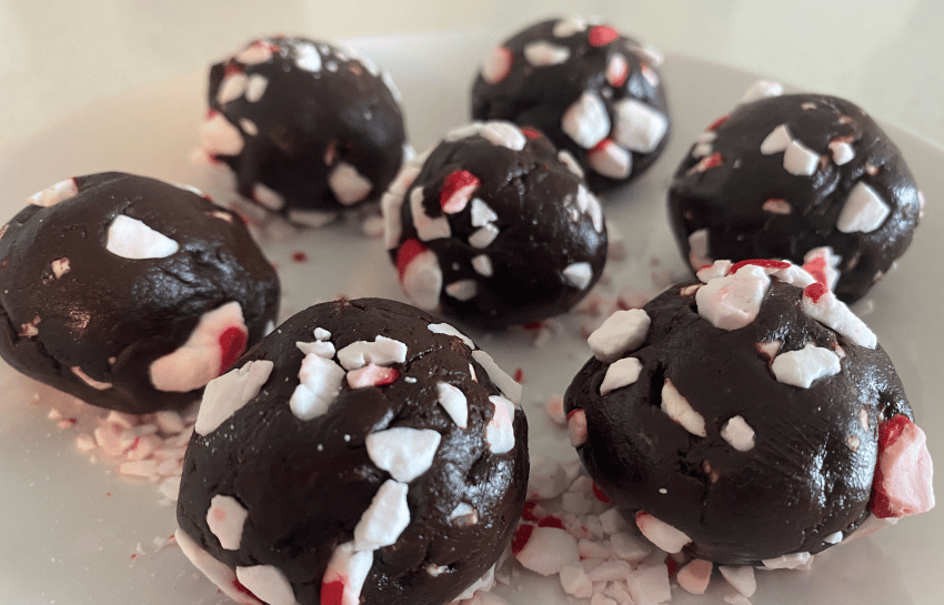 Holiday chocolate peppermint protein balls displayed on a platter
