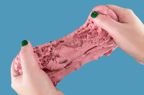 Hands holding cranberry slime