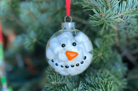Marshmallow snowman ornament holiday craft hanging on Christmas tree