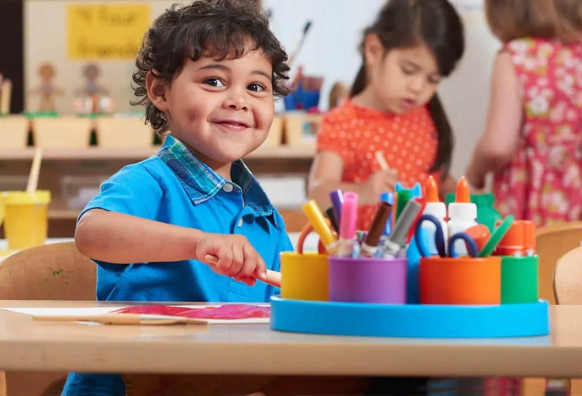 Preschool boy painting at New Horizon Academy daycare center