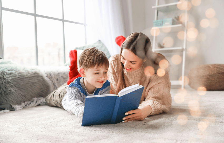 Mother and sun reading together on the floor