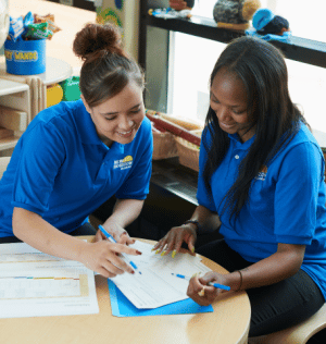 http://Two%20daycare%20teachers%20discussing%20childcare%20costs