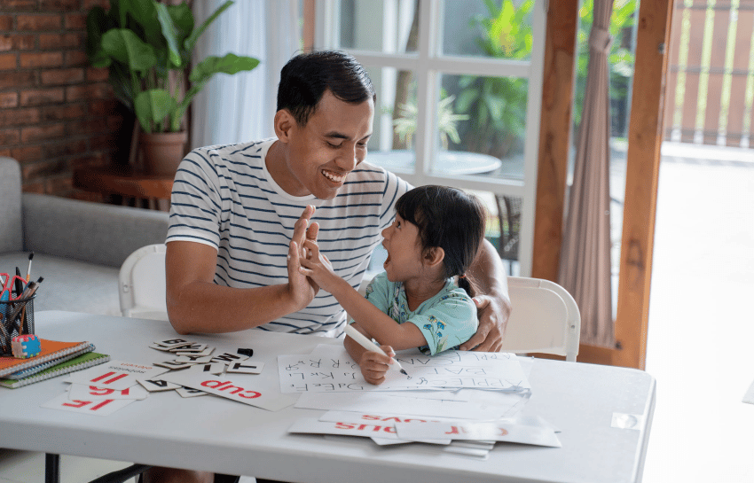 Father and daughter high fiving while setting goals