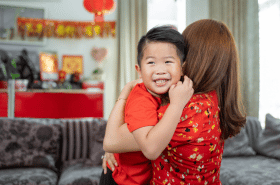 Mother hugging son during Chinese New Year