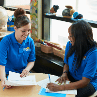 two childcare teachers working on schoolwork