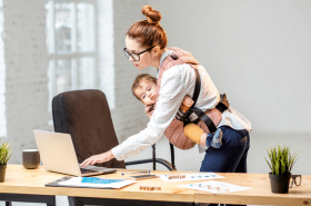 Mother working while parenting her infant