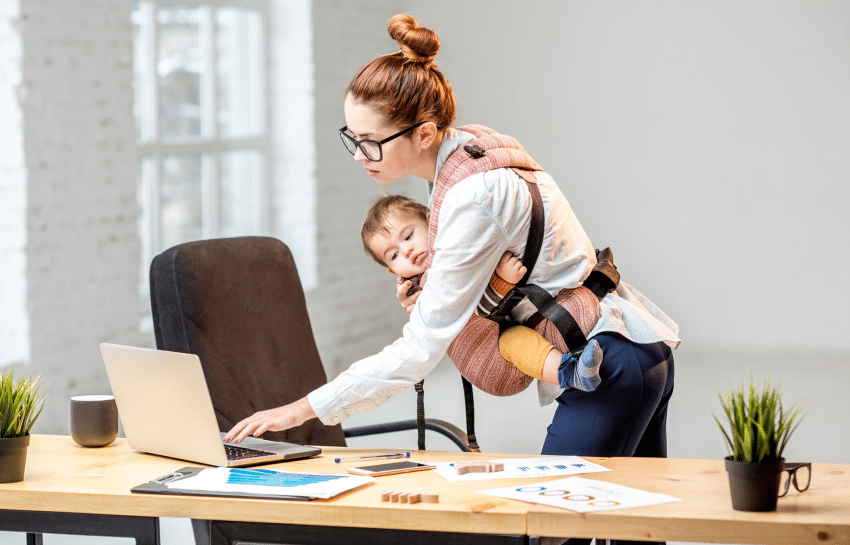 Mother working while parenting her infant