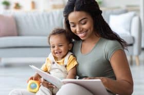 Mother reading a classic board book to her infant son