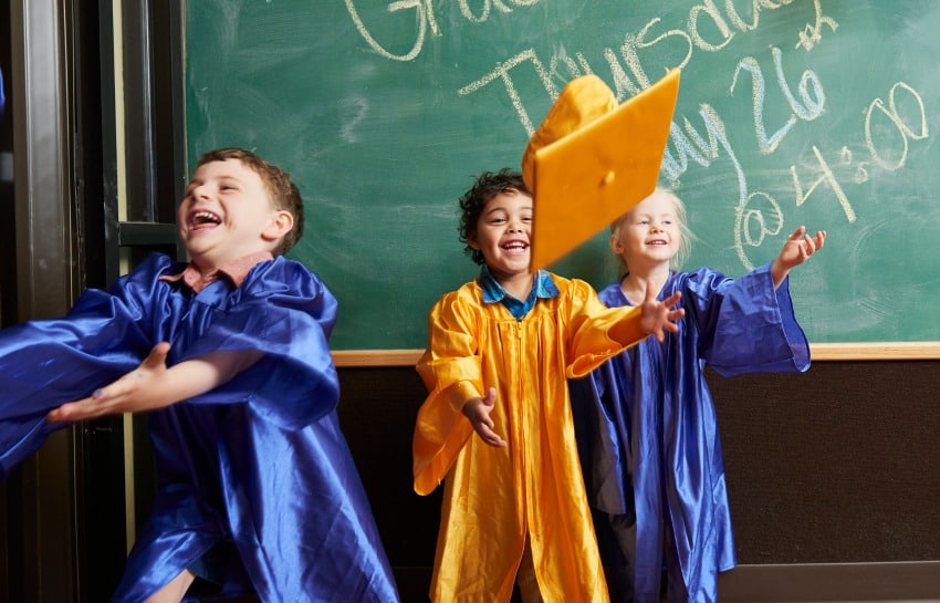 pre-k students tossing graduation hats up in the air to celebrate going off to kindergarten