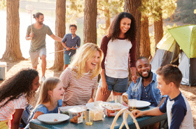 Families celebrating Labor Day with an outdoor picnic with their children