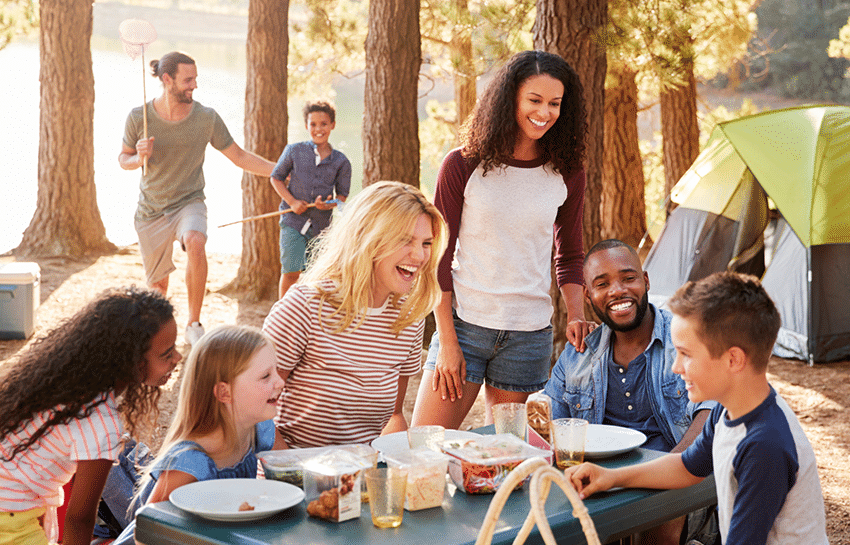 Families celebrating Labor Day with an outdoor picnic with their children