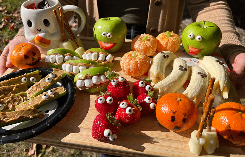 Healthy Halloween party snacks displayed on a charcuterie board