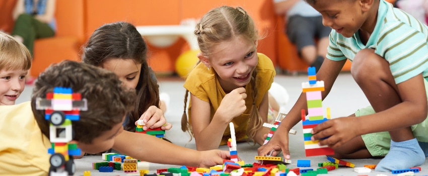 daycare children interacting and playing legos together