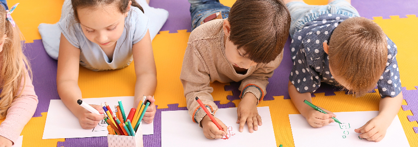 Preschool children practicing drawing and their fine motor skills