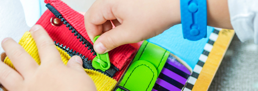 Child practicing with zippers for fine motor activity