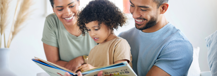 Mother and father helping their preschool son learn to read