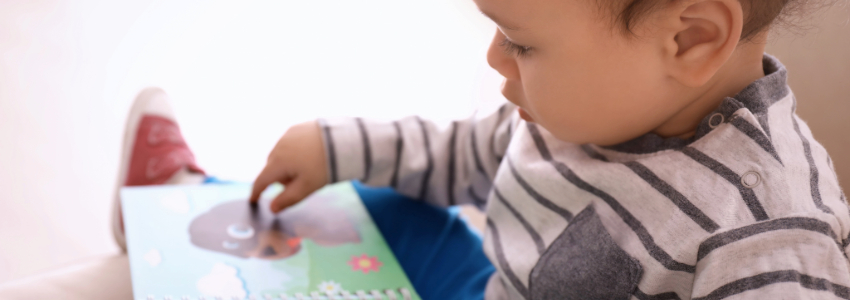 Baby reading age-appropriate picture book