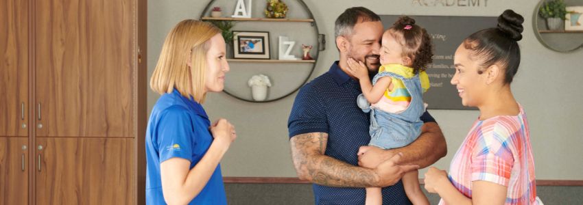 Family touring a New Horizon Academy school before choosing a daycare