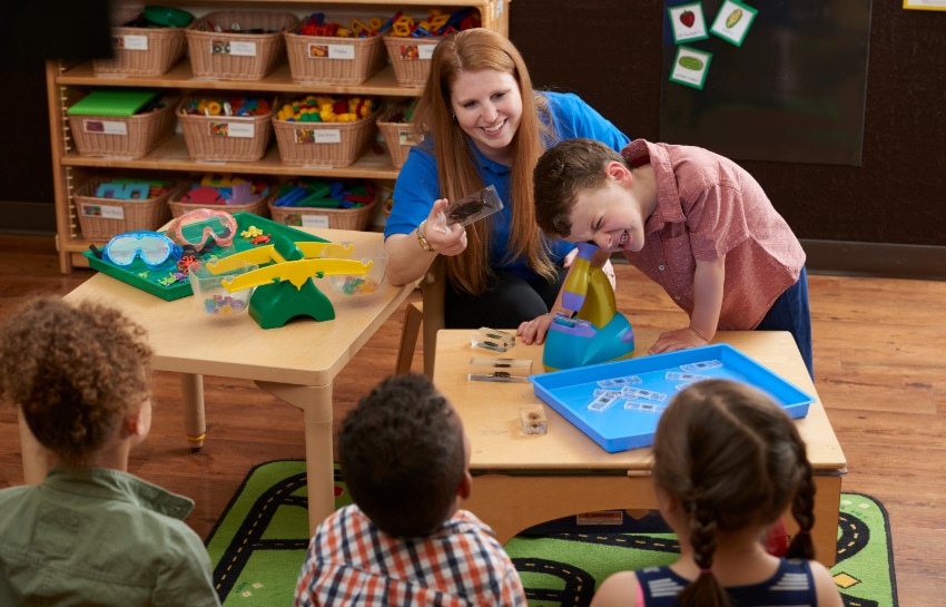 New Horizon Academy preschool children enjoying a STEAM activity with preschool teacher