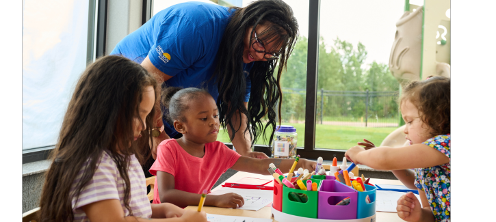 http://Preschool%20teacher%20helping%20pre-k%20children%20practice%20their%20writing%20skills%20at%20school