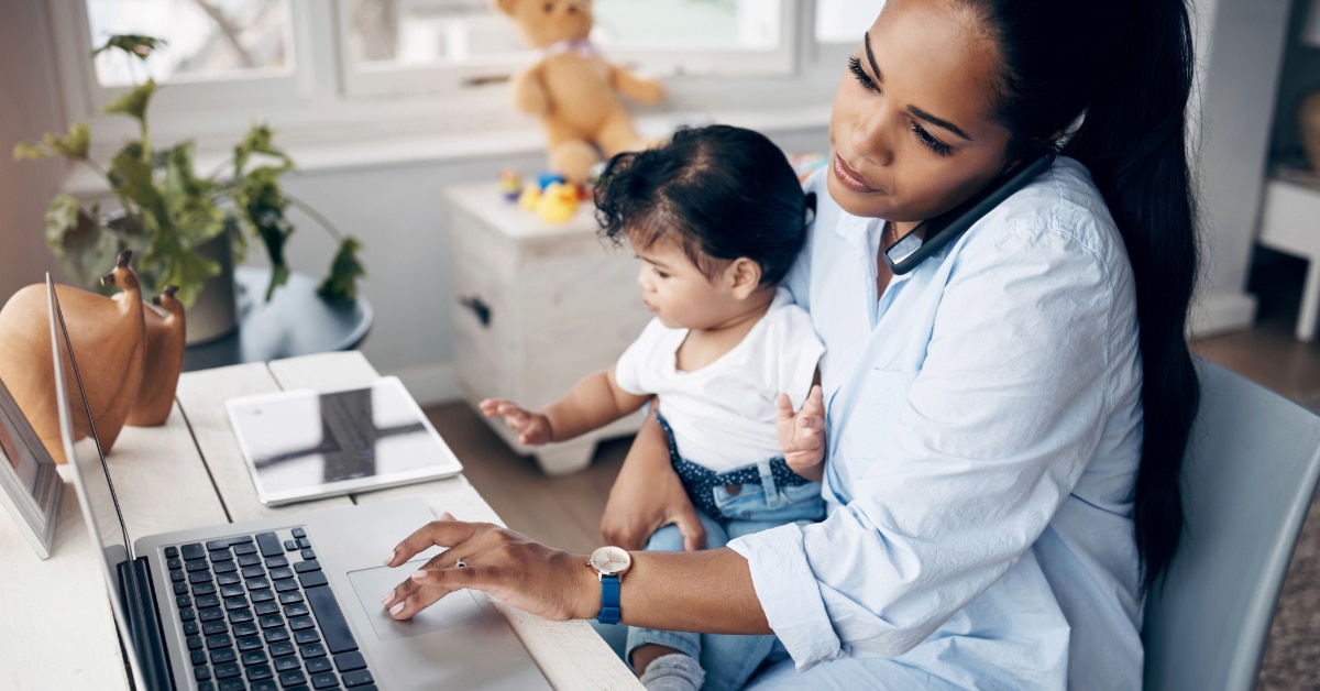 Parent trying to work from home with infant in their lap